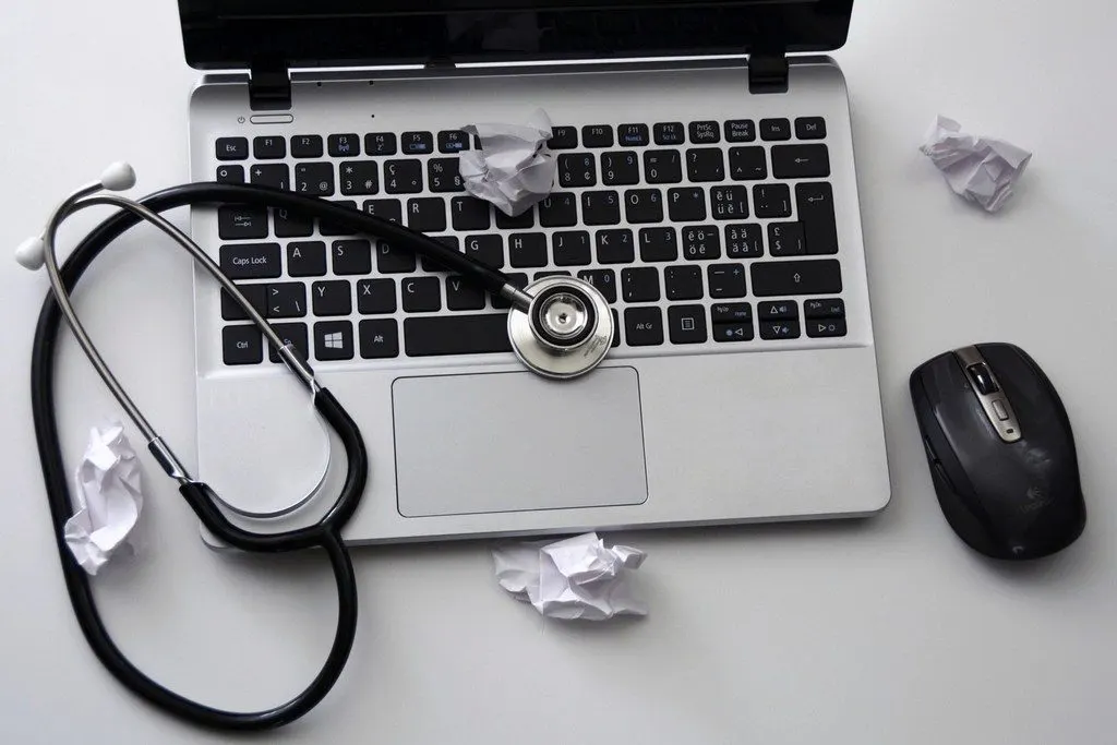 Stethoscope resting on a laptop